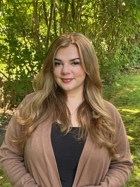 Emily, veterinary technician, smiling outdoors
