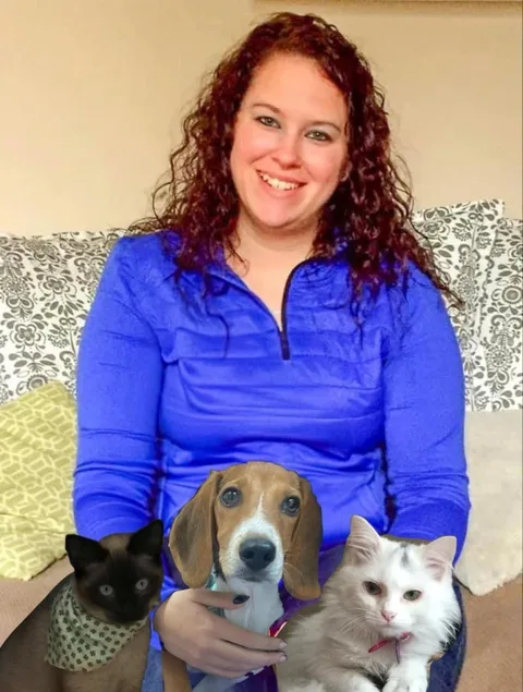 Julie sitting with a dog and two cats